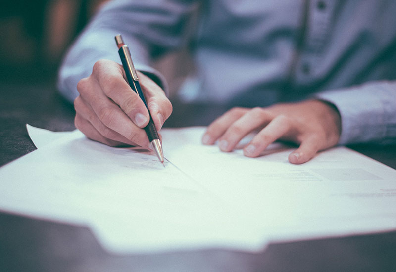 a man signing a document