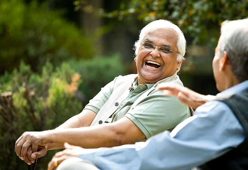friends sharing a story on park bench